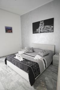 a bedroom with a bed with a cat sitting on it at Central Luxury Apartment in Catania
