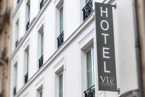 a sign for the vico hotel on the side of a building at Hôtel Vic Eiffel in Paris