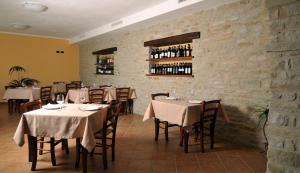 a restaurant with tables and chairs with wine bottles at Agriturismo Cascina Prato in Cravanzana