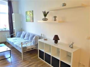 a living room with a couch and a table at Citywohnung an der alten Maschinenfabrik - Nähe Bahnhof in Halle an der Saale