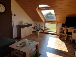 a living room with a table and a large window at Ferienwohnung Hahn, 95129 in Rhauderfehn