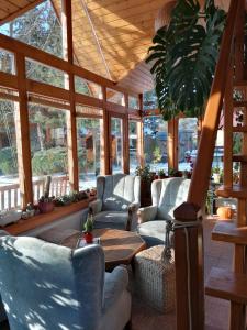 a screened in porch with chairs and a table at Family House - Apartmany Zuzana in Stará Lesná