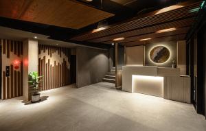 a lobby with a organ and a plant in it at Yunoyado Onsen Hot Spring Hotel Deyang in Jiaoxi