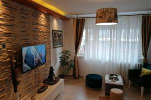 a living room with a brick wall at Oasis felix apartment in Belgrade