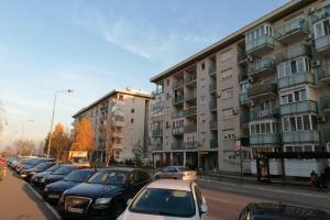 a row of cars parked in front of a building at Oasis felix apartment in Belgrade
