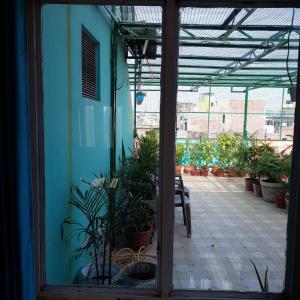 a room with a patio with potted plants at Tara Guest House in Varanasi