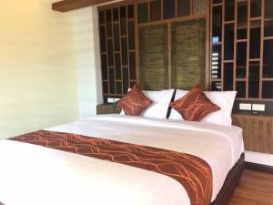 מיטה או מיטות בחדר ב-PS Thungsao Hotel