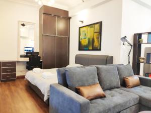 a living room with a couch and a table at Parkview KLCC by Salaam Suites, 4 pax in Kuala Lumpur
