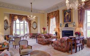 a living room filled with furniture and a fire place at Lucknam Park Hotel in Colerne