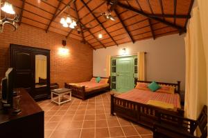 Postel nebo postele na pokoji v ubytování The Vintage Chikmagalur