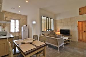 a living room with a couch and a table at Mas des Tourterelles in Saint-Rémy-de-Provence