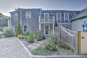 a house with a wooden fence in front of it at Provincetown Vacation Rental with Patio! in Provincetown