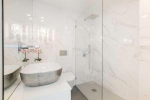 a white bathroom with a sink and a toilet at Casa da Gloria in Lisbon