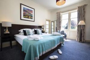 a hotel room with a bed with towels on it at Nether Abbey Hotel in North Berwick
