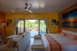 a living room with couches and a large window at CocoLux Luxury Apartments in La Digue +47 photos