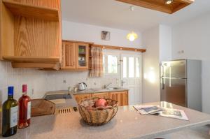 a kitchen with a basket of fruit on a counter at Bernie House in Mélanes +11 photos