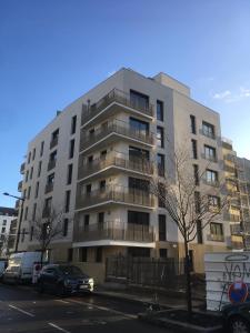 Un grand bâtiment avec des voitures garées devant lui dans l'établissement Appartement avec Balcon Immeuble Standing, à Lyon