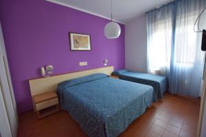 Cama o camas de una habitación en Hotel Azzurra