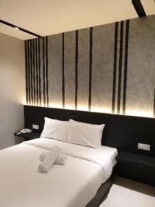 Postel nebo postele na pokoji v ubytování Suite Dreamz Hotel Banting