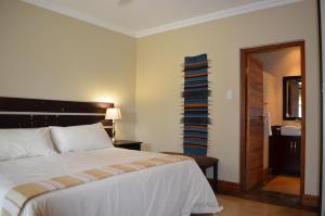 a bedroom with a bed and a stack of towels at Nkonyeni Lodge & Golf Estate in Ngwempisi