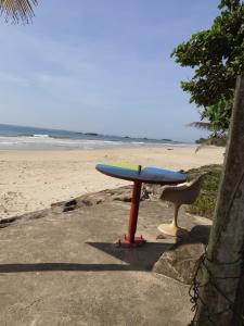 a surfboard on a stand on the beach at Fort Sea View Hotel in Matara