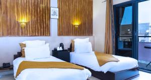 Postel nebo postele na pokoji v ubytování Amani Hotel Suites & Spa