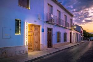 a blue building with wooden doors on a street at Hotel Boutique Arte y Descanso in Almagro