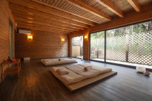 two beds in a large room with large windows at Hotel Santa Marta in Lloret de Mar