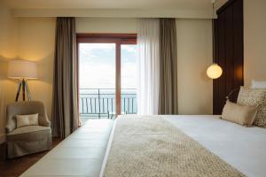 a bedroom with a large bed and a window at Hotel Santa Marta in Lloret de Mar