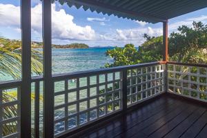 a balcony with a view of the ocean at Bequia Beachfront Villas in Friendship