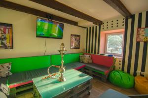 a living room with a couch and a tv on the wall at Lucky Hostel на Крещатике in Kyiv