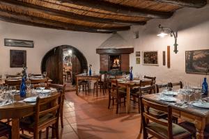 a dining room with tables and chairs and a fireplace at Oude Wellington Estate in Wellington