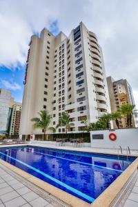 a large apartment building with a large swimming pool at Comfort Suites Brasília in Brasilia