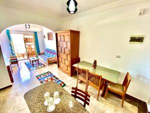 a living room with a table and a dining room at The Castle Hotel & studios in Dahab