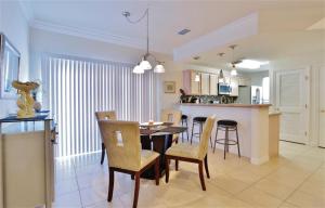 a kitchen and dining room with a table and chairs at South Padre Island Condo with Pool Access and Balcony! in South Padre Island