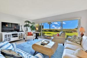 a living room with a couch and a tv at Whitney Beach View 332 in Longboat Key