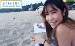 a young woman sitting on the beach at Kenting Location Hotel - Loving Nan Wan in Nanwan