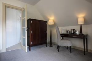 a room with a desk and a chair and a cabinet at Nether Abbey Hotel in North Berwick