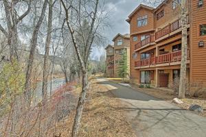 a winding road in front of a building at Cozy Avon Retreat w/ Private Deck & Pool Access! in Avon