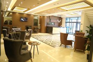 a salon with a waiting room with chairs and a table at EMA ÖZTÜRK THERMAL HOTEL in Afyon