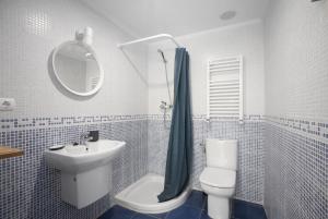 a bathroom with a sink and a toilet and a mirror at Apartamento Balea VII in Orio