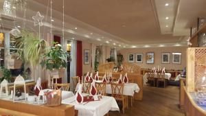 a restaurant with tables and chairs in a room at Hotel Drei König in Immenstadt im Allgäu