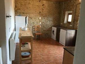 una cucina con frigorifero e tavolo in una camera di Casa Lucas a Ager