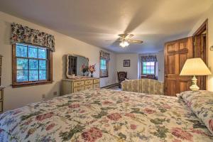 a bedroom with a large bed and a dresser at Waterfront New England House on Wickaboag Lake! in West Brookfield