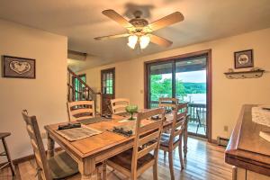 a dining room with a table and a ceiling fan at Waterfront New England House on Wickaboag Lake! in West Brookfield