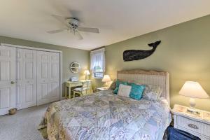 a bedroom with a bed and a ceiling fan at Charming East Falmouth Home Walk to Private Beach in East Falmouth +34 photos