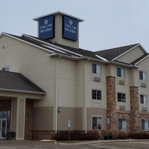 a hotel building with a sign on top of it at Cobblestone Suites - Ripon in Ripon