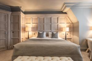 a bedroom with a large bed with two lamps at The Scotsman Hotel in Edinburgh