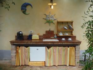 a kitchen with a counter and a table on a wall at Il Cielo Bio - nature, relax, Shiatsu, massage, esplore Chianti in Greve in Chianti