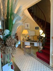 a living room with a staircase and a desk at Victoria Arromanches B&B in Tracy-sur-Mer